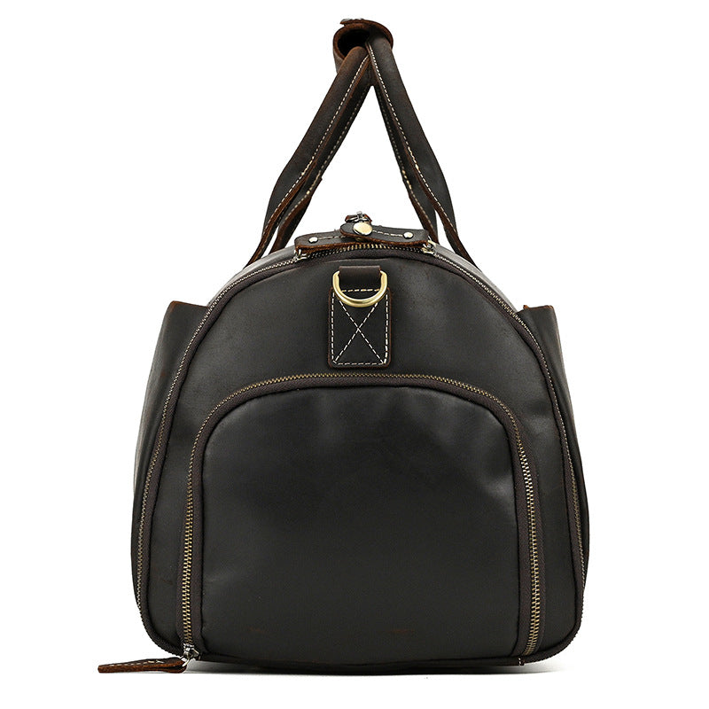 Dark brown vintage leather duffle bag with sturdy handles, side zippers, and brass hardware against a white background.