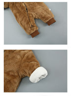 Soft brown fuzzy baby onesie with a zip front and contrasting dark brown cuffs, featuring a cozy white inner lining.