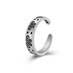 Silver-tone open ring with engraved black butterfly motifs and dots, featuring a vintage hip-hop aesthetic.