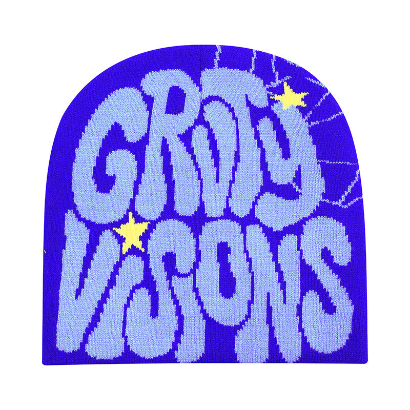 Blue knit beanie with light blue "GROOVY VISIONS" text, small yellow stars, and spiderweb accents in a hip-hop style.