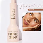 Light pink Pagévine liquid freckle stamp pen with gold text, shown with a model sporting natural-look faux freckles.