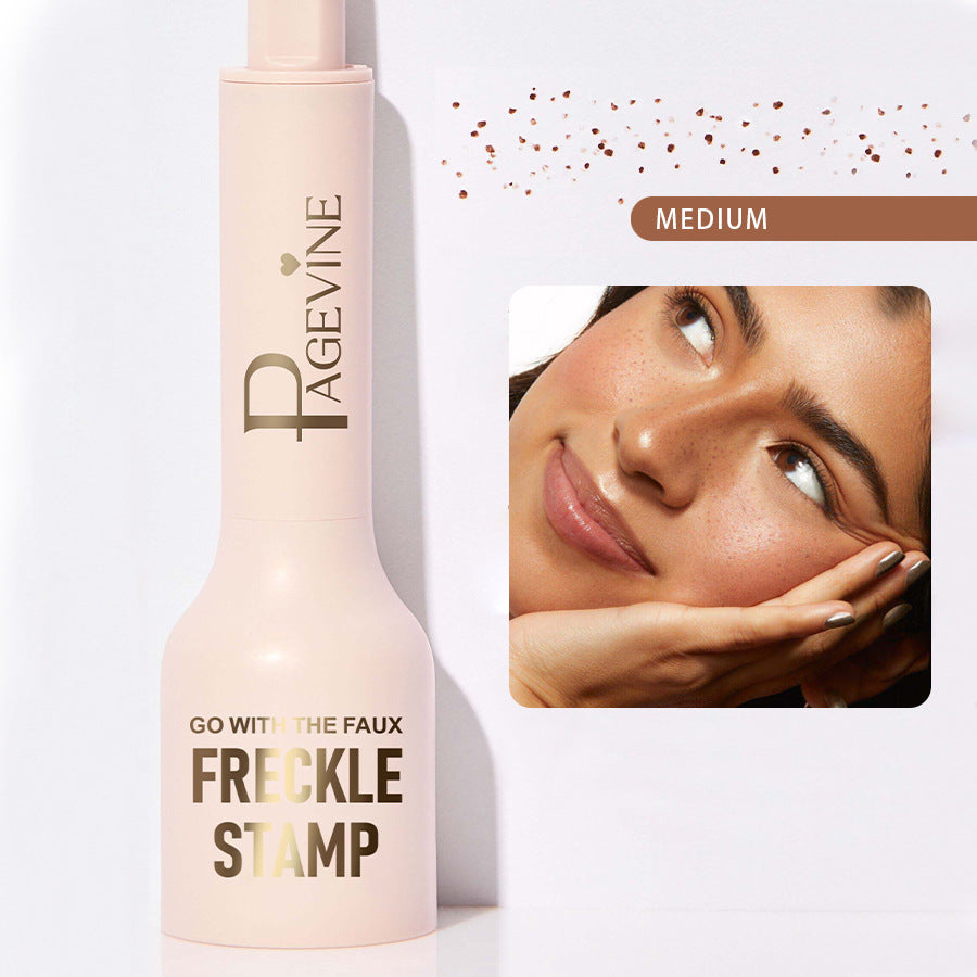Light pink Pagévine liquid freckle stamp pen with gold text, shown with a model sporting natural-look faux freckles.