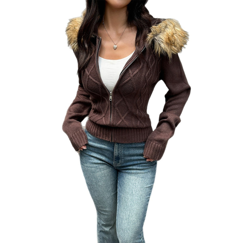 A woman wears a brown cable-knit, zip-up sweater coat with a faux fur-trimmed hood and rib-knit cuffs.