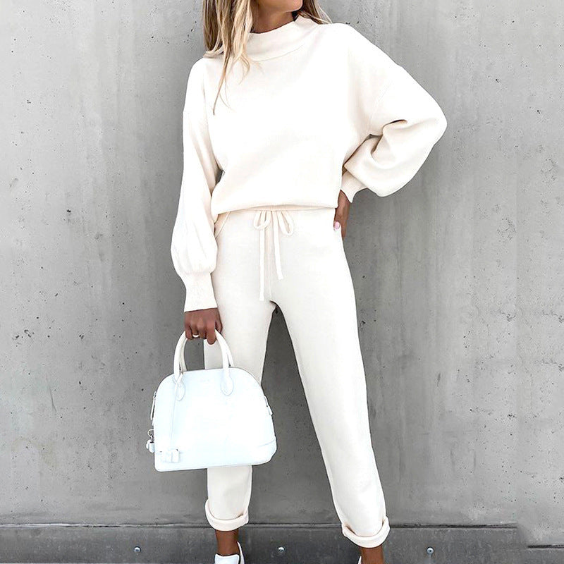 A woman wears a cream-colored long-sleeve fleece sweater set with a mock-neck top and drawstring joggers.