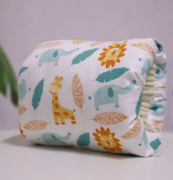 Adjustable cotton nursing arm pillow with a white fabric featuring a colorful animal and leaf pattern.
