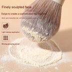 Soft, beige-toned makeup brush with dense bionic fibers picking up fine powder, featured in a sleek marketing graphic.