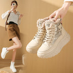 Beige fleece-lined high-top boots with quilted panels, thick platform soles, and lace-up fronts.