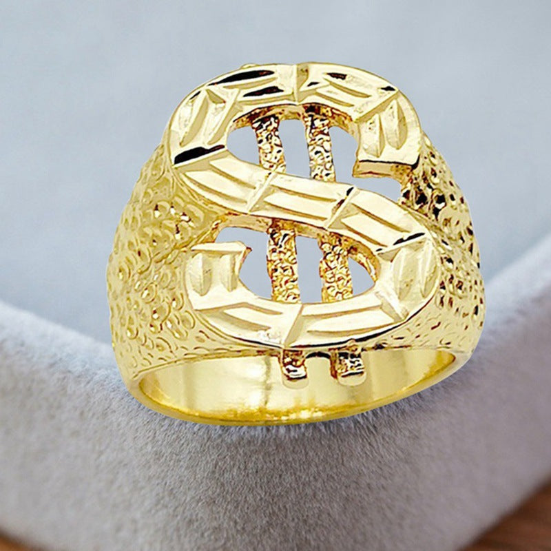 Gold-tone hip-hop ring featuring a prominent dollar sign symbol with a textured, rugged finish.