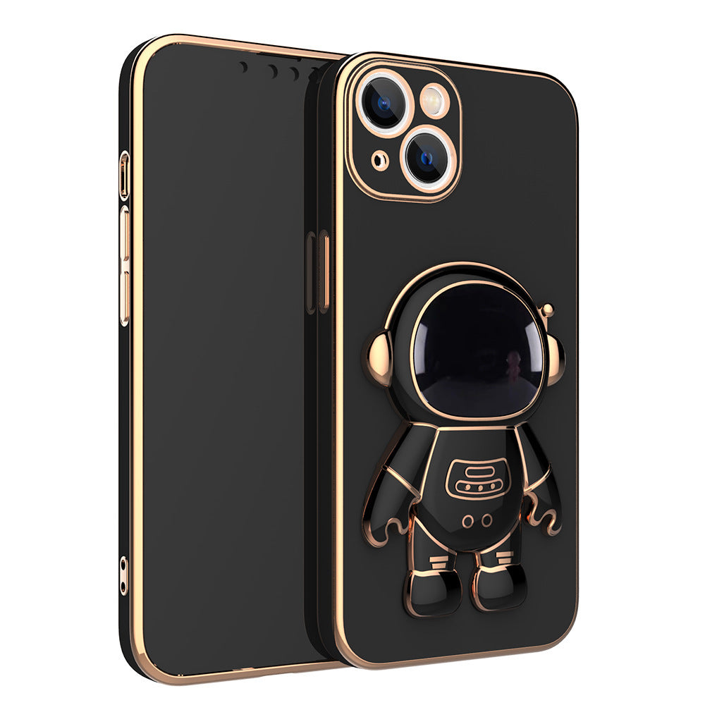 Black phone case with gold electroplated trim and a 3D astronaut figure that serves as a stand.