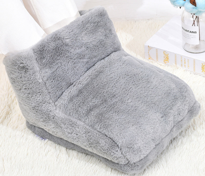 Plush grey USB-powered foot warmer with a soft, fuzzy texture, shown with feet inside on a white faux fur rug.