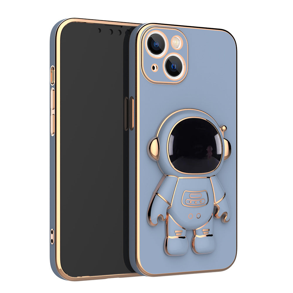 Blue matte phone case with a gold-trimmed 3D astronaut kickstand and camera cutout, featuring electroplated edges.