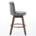 Gray velvet swivel bar stool with tufted back, nailhead trim, and wooden legs with a circular footrest.