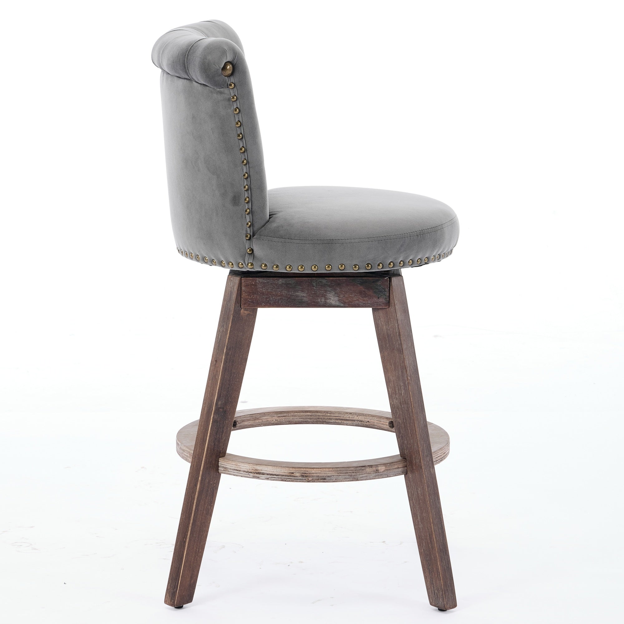 Gray velvet swivel bar stool with tufted back, nailhead trim, and wooden legs with a circular footrest.