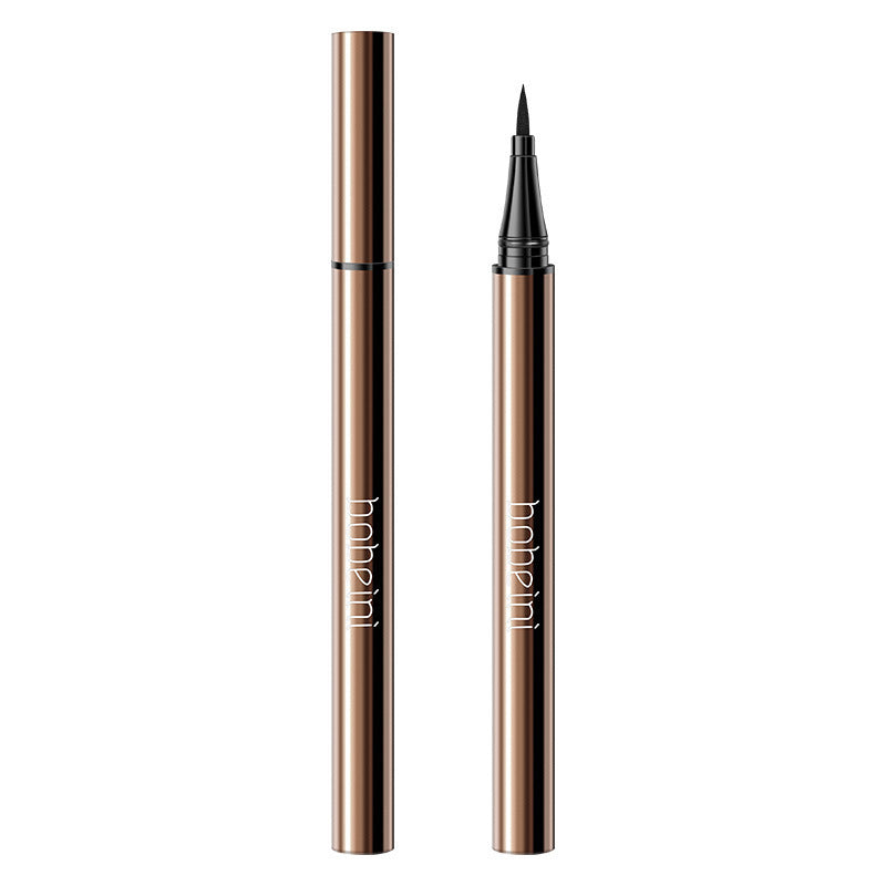 Two metallic bronze liquid eyeliner pens, one capped and one with a fine black felt tip exposed, white background.