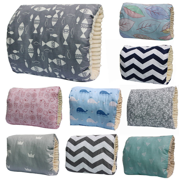 Assorted cotton infant nursing arm pillows in various colorful prints and patterns with plush, washable interiors.
