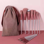 13-piece rose gold and light pink makeup brush set with soft bristles and a matching drawstring storage pouch.