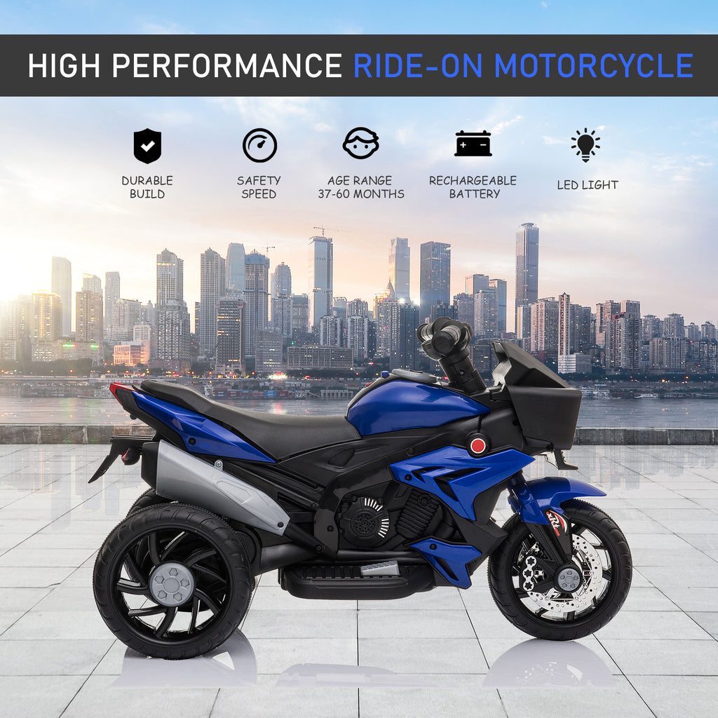 Blue and black electric ride-on motorcycle for kids with three wheels, LED lights, and a cityscape background.