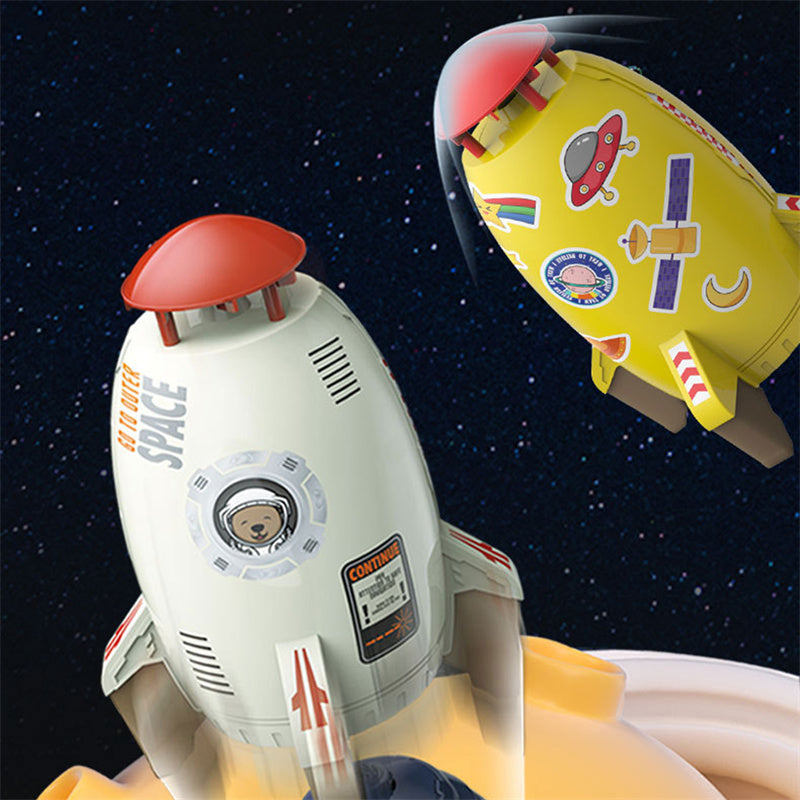 White and yellow plastic rocket water sprinkler toys with space-themed decals against a starry background.