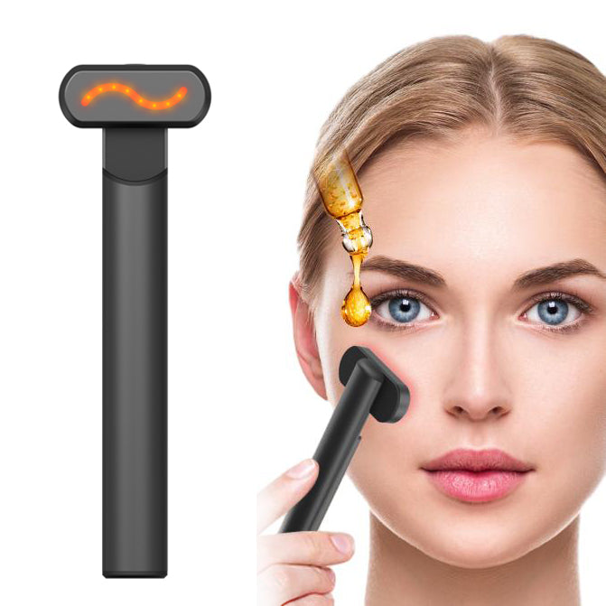Black 4-in-1 LED red light therapy wand being used on a woman's face next to a drop of facial serum.