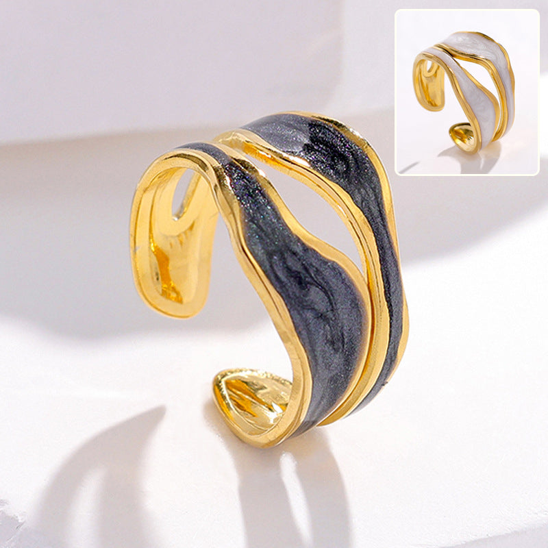 Gold titanium steel open-toed ring featuring wavy black or white enamel inlay in a stylish, modern cutout design.