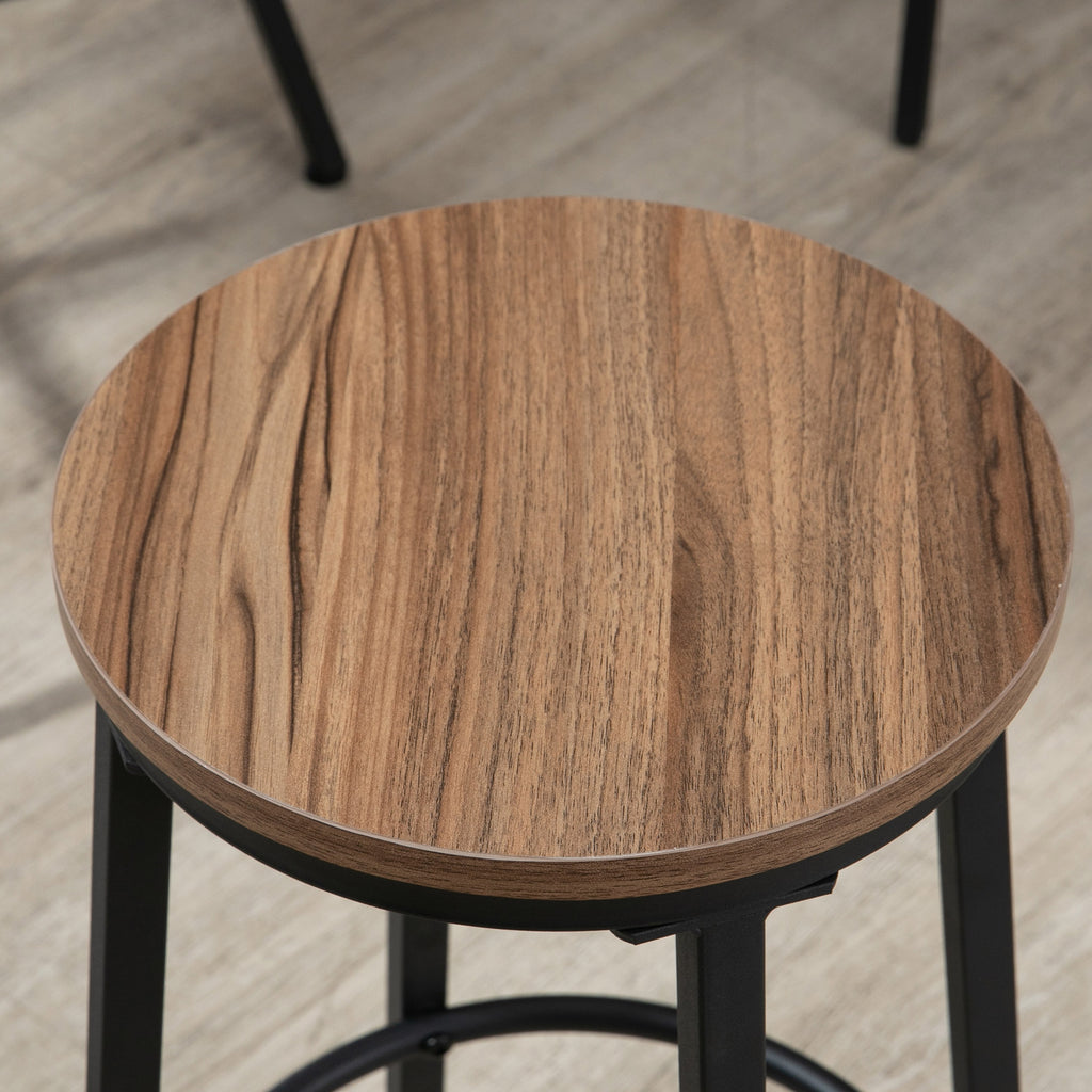 Close-up of a round bar stool with a brown wood-grain top and a sturdy black metal frame.