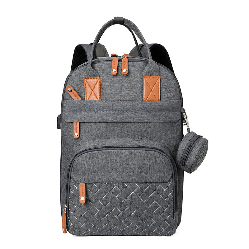 Charcoal gray stroller backpack with tan leather accents, quilted front panel, and a small matching detachable pouch.
