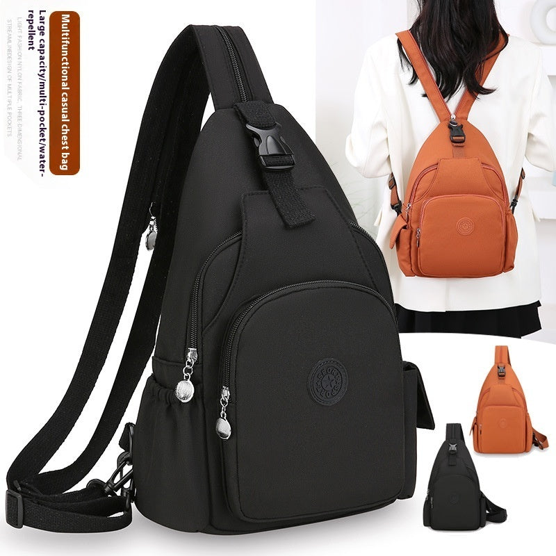 Black and orange waterproof nylon sling chest backpacks with multiple pockets, adjustable straps, and zipper closures.
