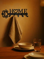 Black metal wall hook set featuring a "HOME SWEET HOME" design with a heart, mounted on a wall with a hanging cloth.