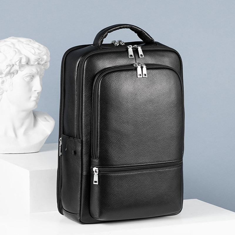Black, large-capacity pebbled leather business backpack with silver zippers, USB port, and top carry handle.