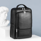Black, large-capacity pebbled leather business backpack with silver zippers, USB port, and top carry handle.
