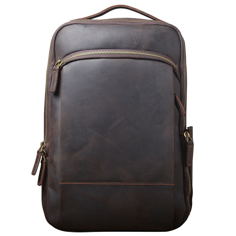 Dark brown leather backpack with a vintage finish, brass zippers, and a sturdy top handle against a white background.