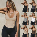 A model wearing a slim-fit, scoop-neck ribbed knit tank top available in various neutral colors with black leggings.