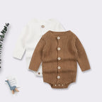 Two long-sleeve, ribbed-knit baby bodysuits in white and brown, each featuring a front button placket and snap closure.