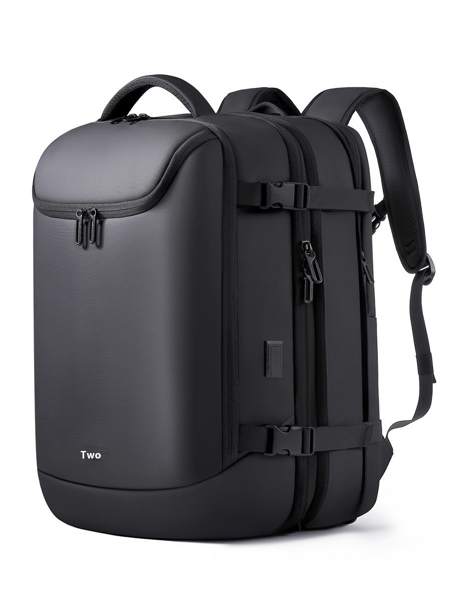 Black, minimalist vacuum compression backpack with side compression straps, top handle, and durable matte finish.