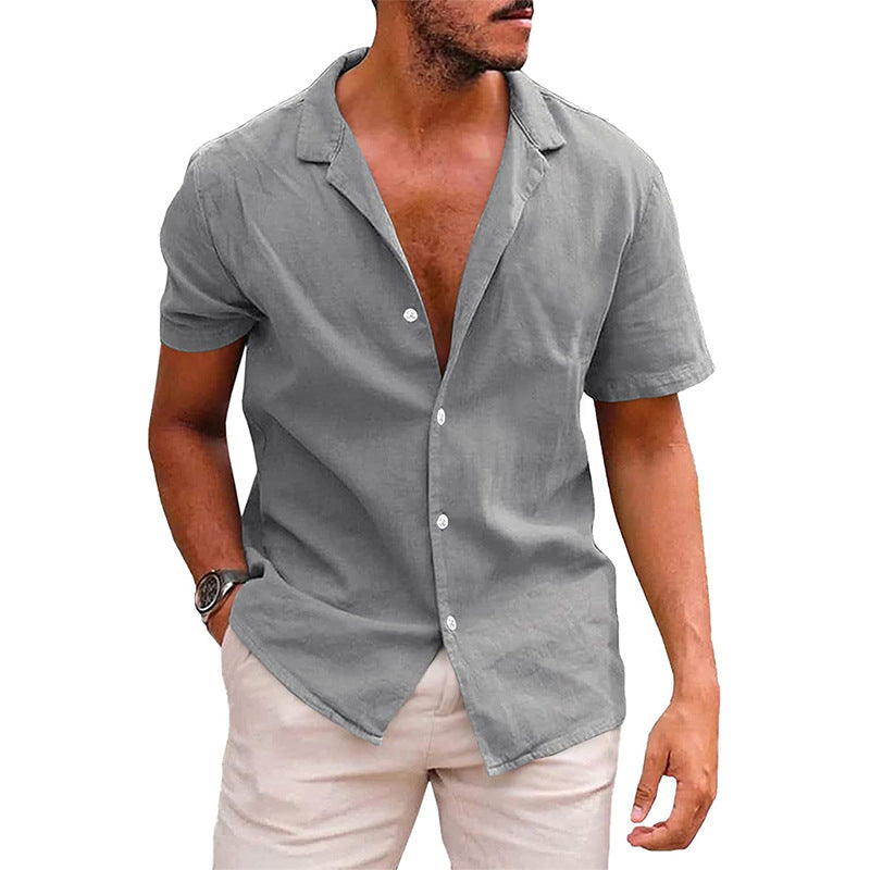 A man wearing a short-sleeve, gray button-down camp shirt in a lightweight linen-blend fabric with a notched collar.