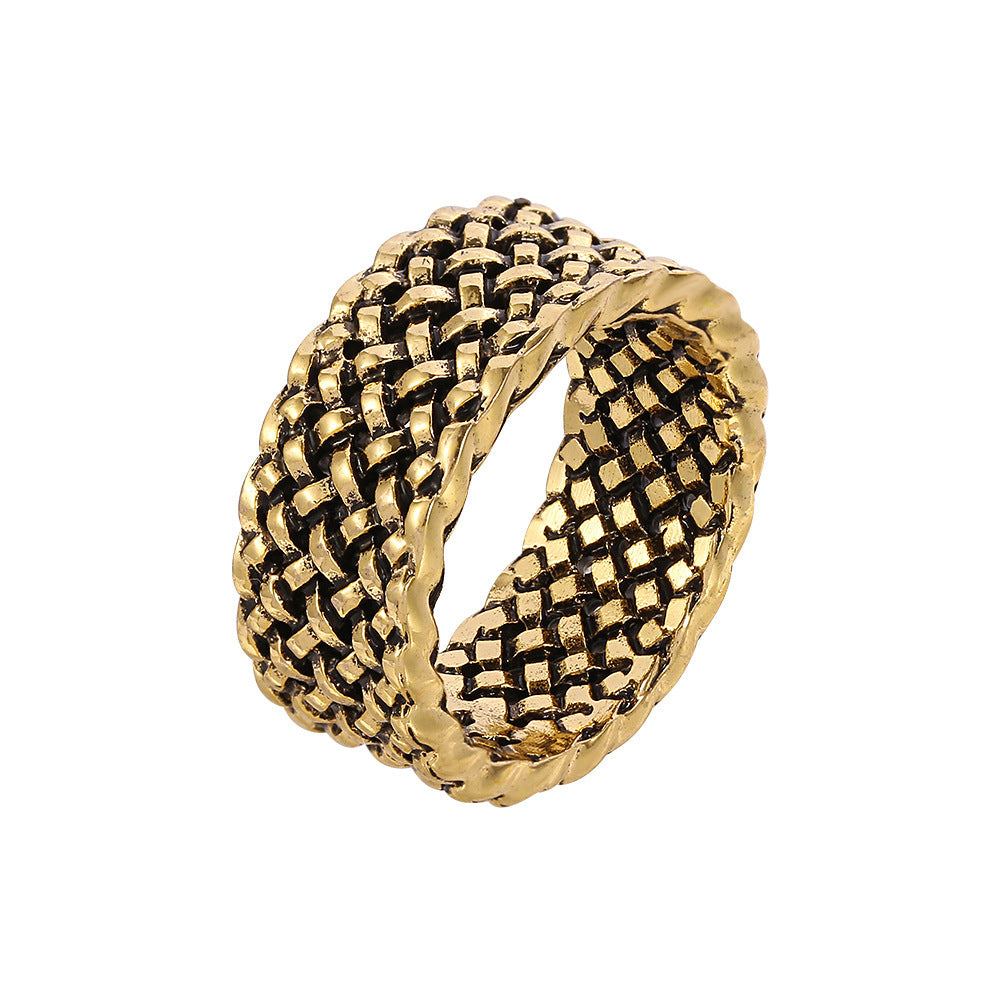 A gold-tone hip-hop style ring featuring a wide, intricate woven mesh design with a dark oxidized finish.