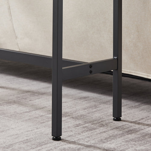 Close-up of a bar table's black metal frame legs with adjustable feet on a grey textured carpet.