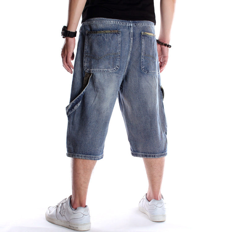 Back view of loose-fit, light-wash denim hip-hop shorts with multiple pockets, cargo detailing, and contrast trim.