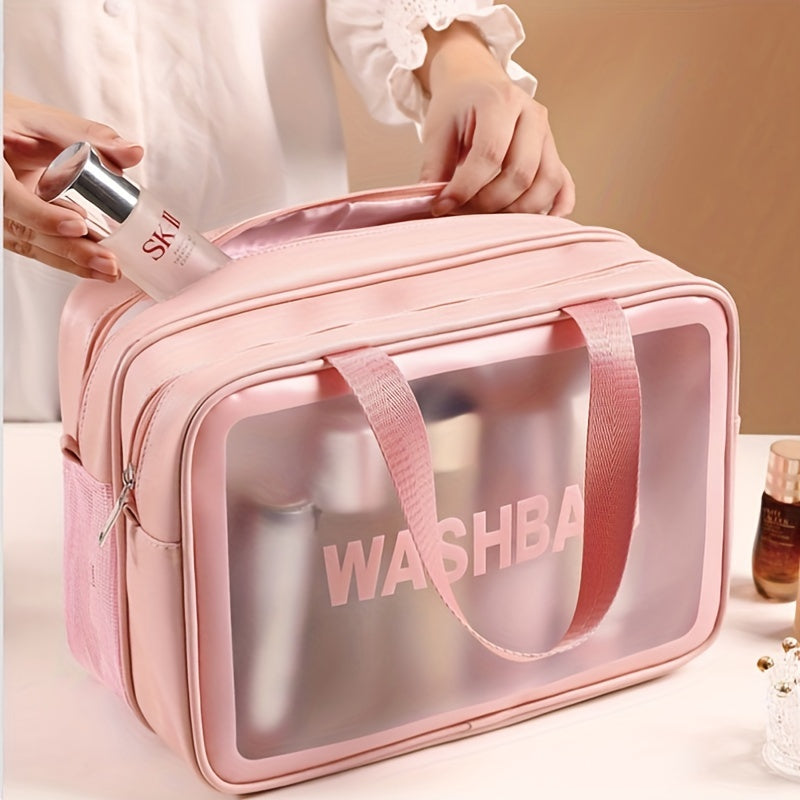 Pink travel makeup bag with a clear front panel, "WASHBA" lettering, top handles, and zipper closures.