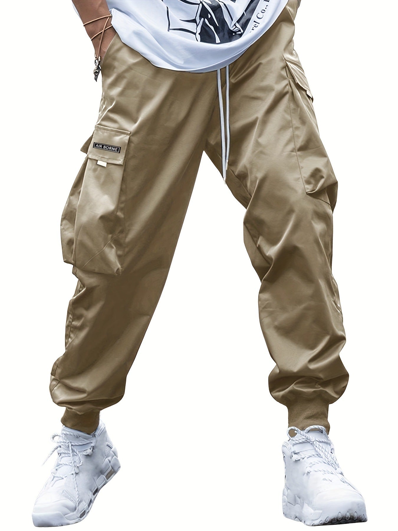 Tan cargo pants featuring a drawstring waist, side cargo pockets with "AIR BORNE" label, and ribbed ankle cuffs.