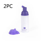 V34 purple teeth whitening foam in a white pump bottle with a dollop of purple mousse on a white background.