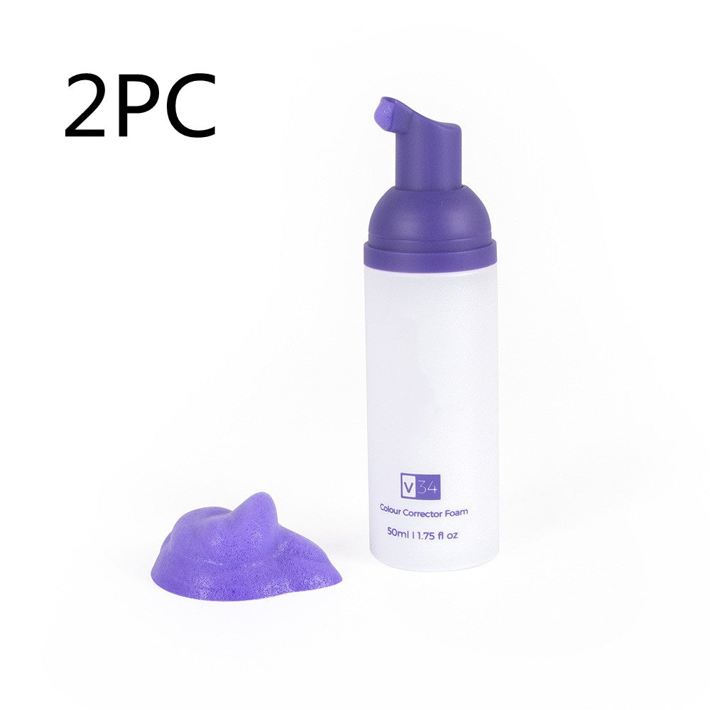 V34 purple teeth whitening foam in a white pump bottle with a dollop of purple mousse on a white background.