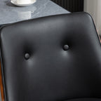 Black tufted faux leather bar stool backrest with a warm wood frame next to a grey marble tabletop.