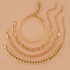 Set of four gold-toned hip hop bracelets featuring various chain styles, including a thin bangle and Cuban link chain.