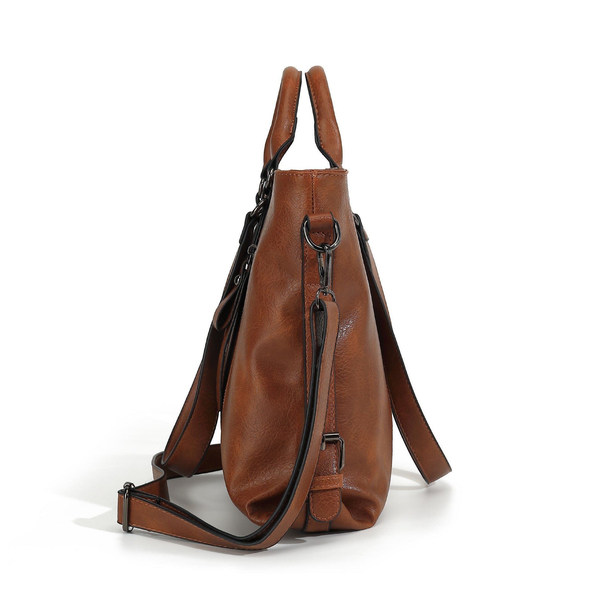 Side view of a brown soft leather tote bag with top handles, black hardware, and an adjustable shoulder strap.