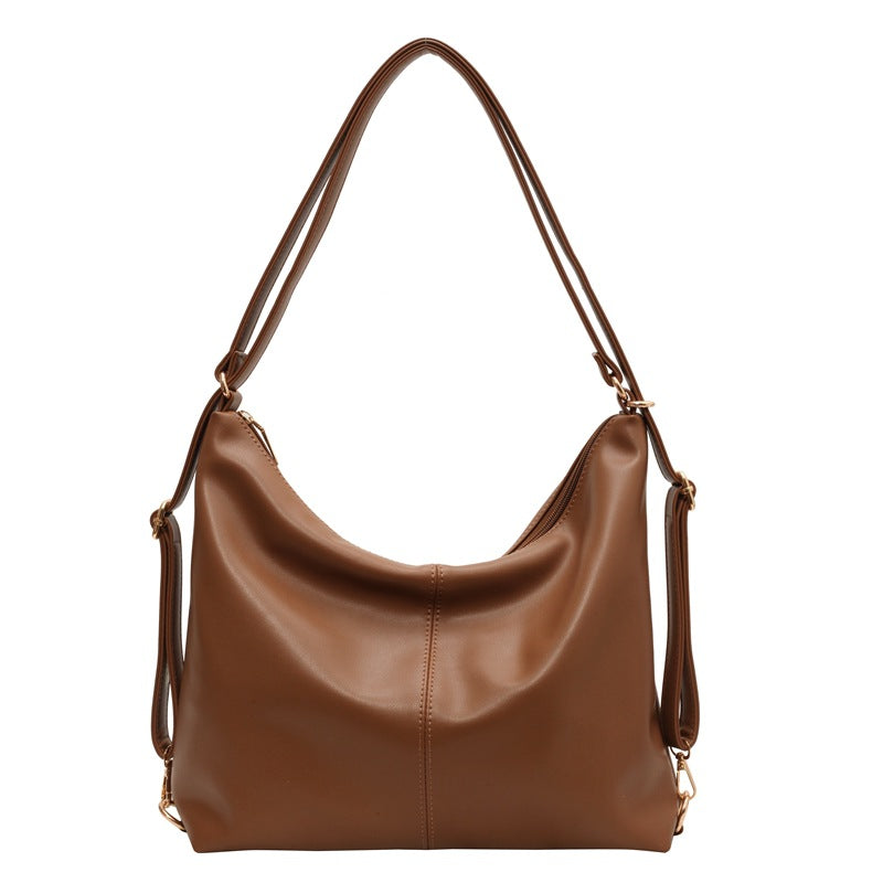 Brown PU leather hobo shoulder bag with a slouchy design, gold-tone hardware, and adjustable straps on a white bg.