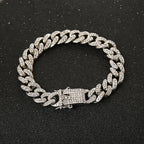 Silver-tone Cuban link chain bracelet encrusted with clear rhinestones on a black background.