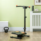 Black foldable ab twister board with orange foot pads, handlebar, and digital fitness monitor on a wooden floor.