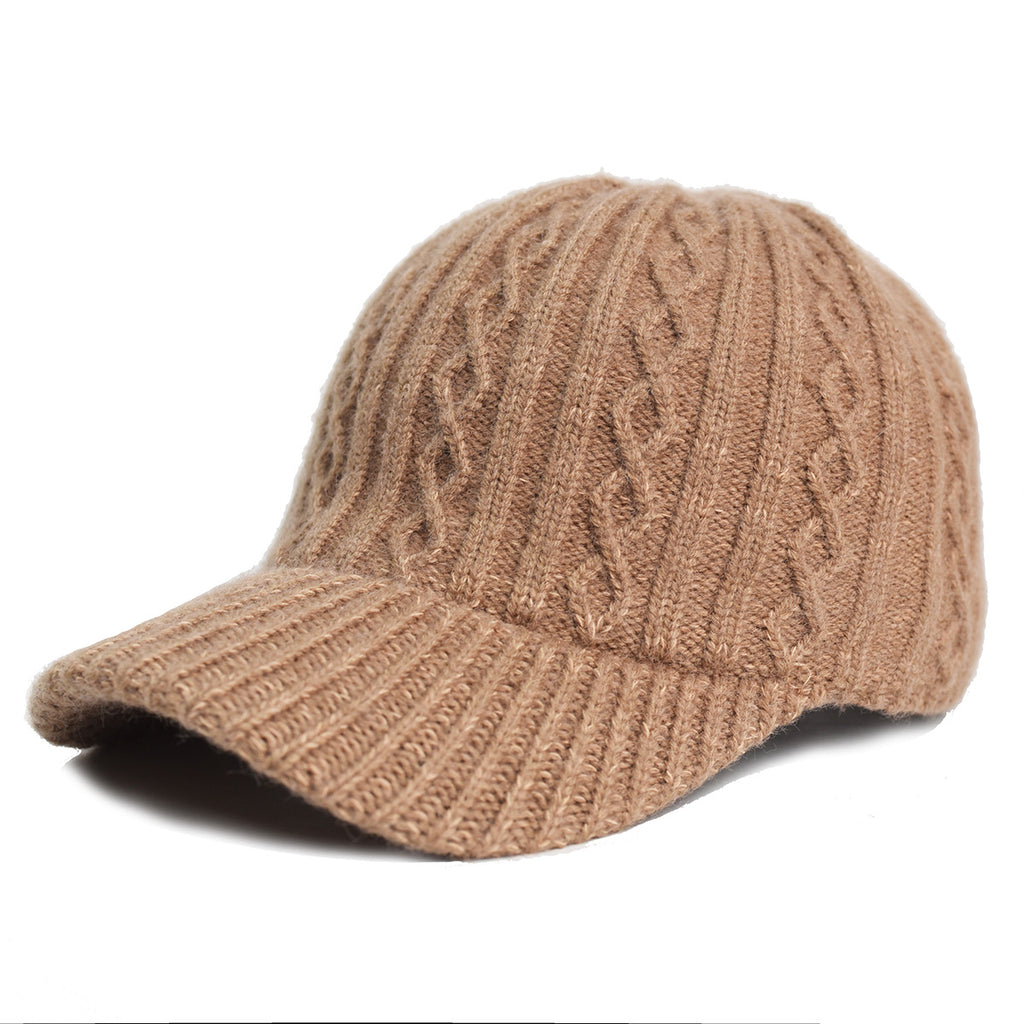 Tan knit baseball cap with vertical cable-knit texture and a structured, ribbed brim against a white background.