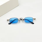 Retro-style thin, rectangular sunglasses with silver metal frames and vibrant blue tinted lenses.